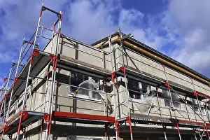 Residential Construction Site Drucke: New building with completed basic rendering of the exterior facade New building with completed basic rendering of