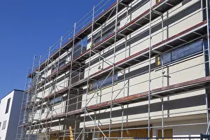 Residential Construction Site Drucke: New building with completed basic rendering of the exterior facade New building with completed basic rendering of