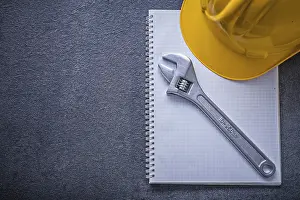 Construction Industry Safety Equipment Drucke: Notebook hard hat adjustable wrench construction concept