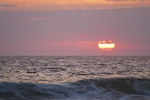 Ocean Sunset Drucke: Ocean waves on sunset with setting sun background