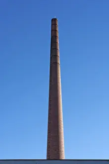 Abandoned Industrial Plant Drucke: Old actory chimney made of bricks