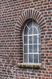 Old Brick Wall Drucke: Old brick wall with an arched window and a rustic architectural style