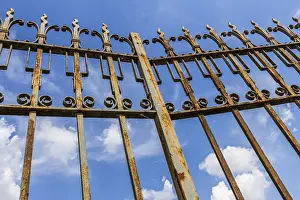 Blue Sky Background Drucke: Old gate rusty in the foreground on blue sky background with clouds