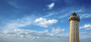 Cloudy Atmospheric Mood Drucke: Old lighthouse in the blue sky
