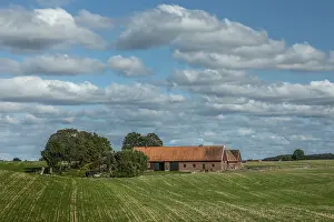 Cloudy Scandinavian Landscape Drucke: Old red farm under cloud in Baldinge