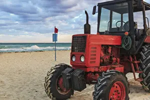 Empty Beach Scene Drucke: Old red tractor on the sandy beach
