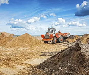 Historic Excavation Site Drucke: Old roadworking tractor working with construction sand