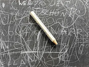 Deserted Classroom Scene Drucke: Old school blackboard with pen and scribbles on the board