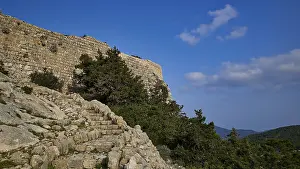 Historic Greek Castles Drucke: An old stone wall surrounded by steps and trees