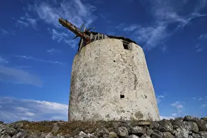 Aegean Sea Landscape Photography Drucke: Old windmill tower against a deep blue sky with clouds