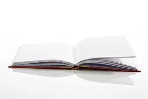 Indoor Still Life Photography Drucke: Open book, scribbling pad