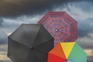 Deserted Cloudscape Drucke: Open umbrellas with storm gray cloud background