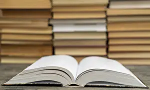 Bookshelf Furniture Drucke: Opened thick book. Symbol of wisdom