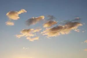 Blue Sky Drucke: Orange fluffy cloud in a blue sky