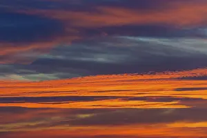 Evening Light Of The Sun Drucke: Orange glowing clouds in the evening sky