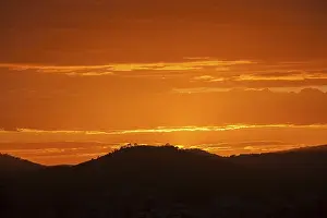Sunset In Southern Europe Drucke: Orange sunset, hill in backlight