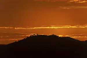 Mallorca Evening Atmosphere Drucke: Orange sunset, hill in backlight