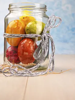 Traditional Easter Egg Display Drucke: Organic colored Easter eggs in a glass with a thin bow