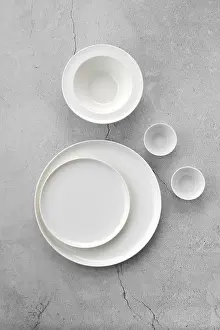 Grey Background Drucke: Overhead view of white tableware on grey background