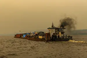 Evening Light On Water Drucke: Overloaded riverboat on the Congo river at sunset