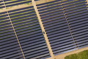 Alternative Energy Source Europe Drucke: Overview of solar panel fields with a car on a dirt path