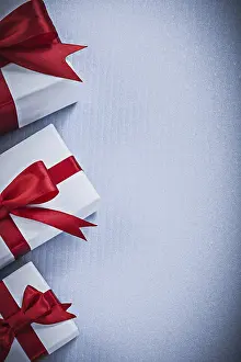 Christmas Present Packaging Drucke: Pacckaged gift boxes on white surface holidays concept