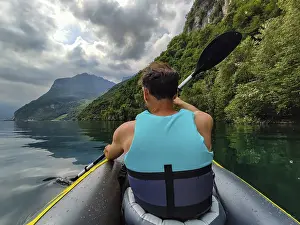 Lake Como Photography Drucke: Paddle on Lake Como in a cloudy day