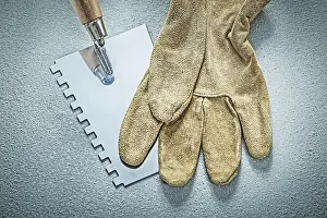 DIY Repair Maintenance Drucke: Paint scraper leather protective gloves on concrete surface construction concept