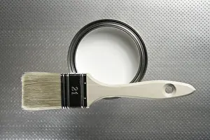 Deserted Studio Setup Drucke: Painter brush and white paint tin macro over silver pattern background