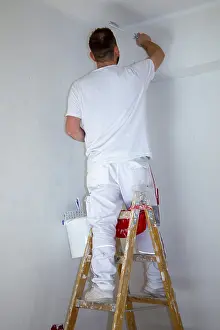 Construction Workman Drucke: Painter renovates an old flat