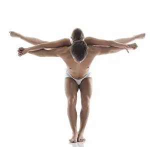 White Background Acrobatics Drucke: Pair of acrobats doing trick in studio