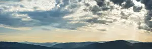 Hilly Countryside View Drucke: Panorama, dramatic clouds and silhouette of hills