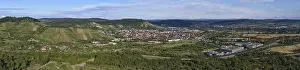 Urban Environment In Southern Germany Drucke: Panoramic view of a city in a hilly landscape with fields and clouds