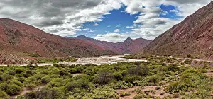 Quebrada De Cafayate Landscape Drucke: Panoramic view of red mountains and vegetation with clouds