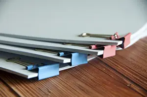 Business Attire Model Drucke: Paper stack of pile of documents on wooden desk