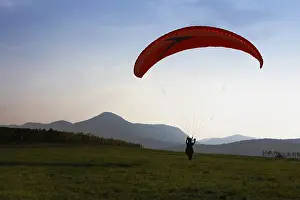Southern Germany Leisure Activity Drucke: Paraglider practicing on a meadow