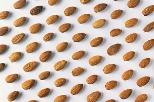 Plain Colored Background Design Drucke: Pattern of almond nuts on a white background