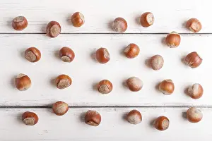 Vegan Diet Food Image Drucke: Pattern and texture made from hazelnuts on white wooden background