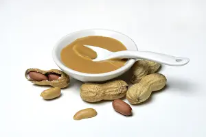 Studio Shot Of Peanuts Drucke: Peanut puree in shell and peanuts, Germany