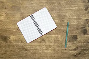 Uninhabited Study Space Drucke: Pencil and open notebook on the table.Top view