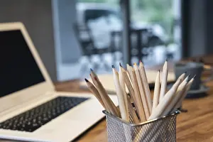 Deserted Office Space Drucke: Pencils and laptop on the table with nobody