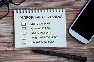 Performance Appraisal Checklist Drucke: Performance appraisal checklist on notepad with with office setting background