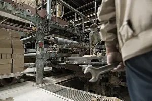 Factory Plant Equipment Drucke: Photo of worker in workshop for bricks production