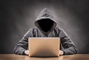 Data Security Threats Drucke: picture of a hacker on a computer