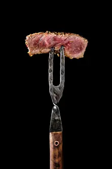 Close Up Steak Drucke: Piece of medium rare steak on the fork