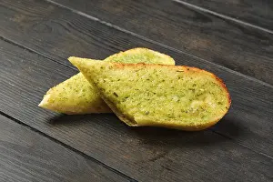 Homemade Garlic Bread Drucke: Two pieces of garlic bread on a table
