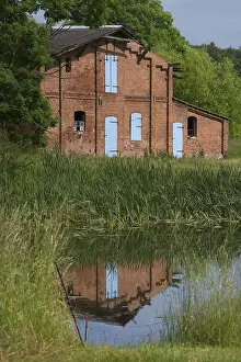 Deserted Livestock Farm Drucke: Former pigsty reflected in the pond