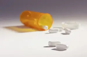 Medical Remedy Drucke: Pills and fallen bottle with dramatic lighting