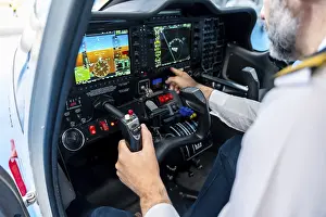Aviation Training Drucke: Pilot prepares for flight at the cockpit controls