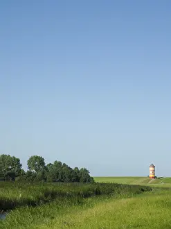Deserted German Village Scene Drucke: Pilsum lighthouse in the background